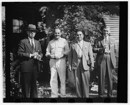 Allen Ramsey Wurtele, second from left, inventor of mechanical sugarcane harvester with sugarcane experts who came up from General International Convention to see his harvester. Mix, Louisiana