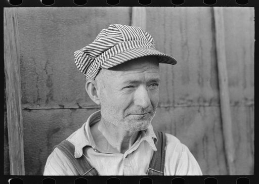 Untitled photo, possibly related to: Day laborer with sugarcane knife in front of his shack home near New Iberia, Louisiana
