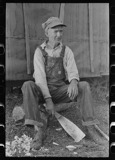 Untitled photo, possibly related to: Day laborer with sugarcane knife in front of his shack home near New Iberia, Louisiana