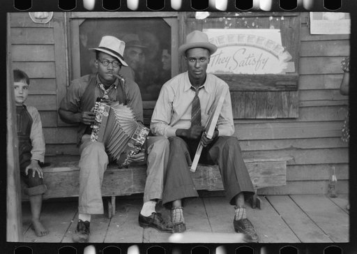 Negro musicians playing accordion and washboard in front of store, near New Iberia, Louisiana