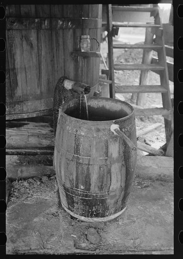 Distillate from turpentine still separates into two layers of water and spirits of turpentine which are easily removed from one another, State Line, Mississippi