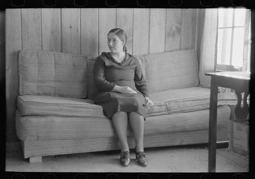 Wife of Chicot Farms homesteader sitting on homemade sofa, Chicot Farms, Arkansas