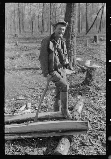 Farmer of Chicot Farms, Arkansas resting after chopping wood