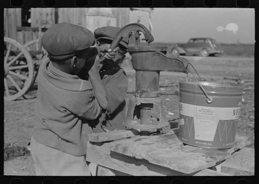 Children of Negro sharecropper pumping water. Family will be resettled at Transylvania Project, Louisiana