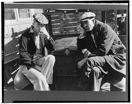 Farmers sitting on fenders of trucks, Laurel, Mississippi