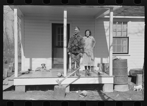Husband and wife on porch of home, Chicot Farms, Arkansas