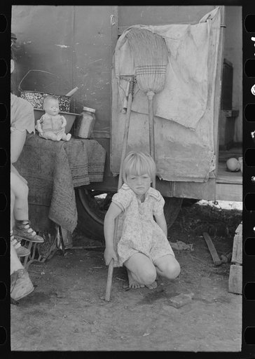 Child of white migrant worker in front of trailer home, Weslaco, Texas