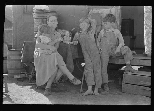 White migrant mother with children in front of trailer home, Weslaco, Texas