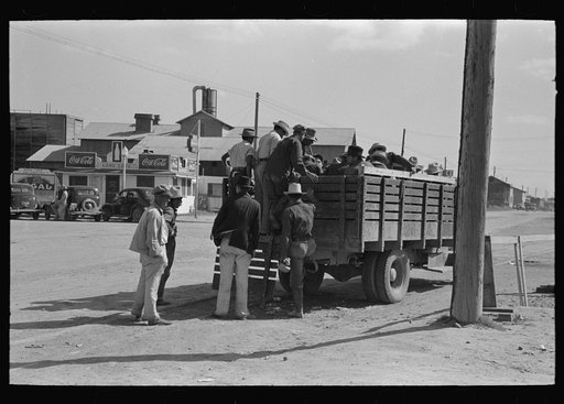 Mexican day laborers being loaded into truck for transportation to field, Weslaco, Texas