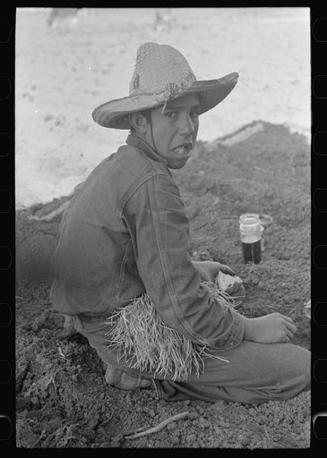 Untitled photo, possibly related to: Young Mexican boy, carrot worker, eating "second breakfast" in field near Santa Maria, Texas. The lunches of the Mexican workers usually consist of tortillas and fried onions and cold coffee