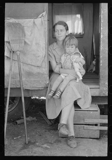 White migrant mother with daughter in door of trailer home near Weslaco, Texas