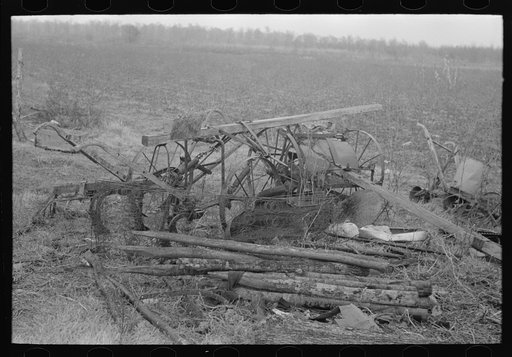Because of lack of storage space it is necessary to keep agricultural implements in the open. Sharecropper farm near Pace, Mississippi. Background photo for Sunflower Plantation