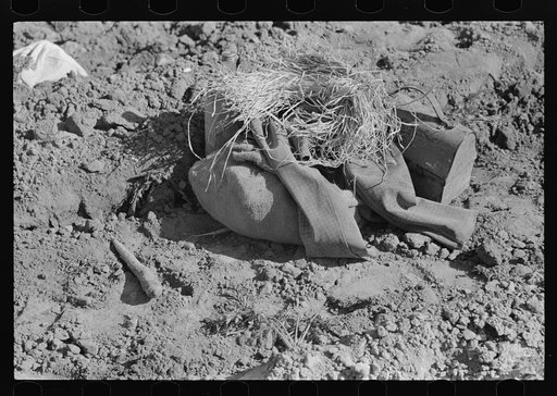 Lunch pail, coffee bottle and coat and straw of Mexican carrot worker, Edinburg, Texas