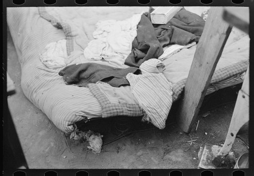 Bed of white migrant worker consisting of mattress on the ground near Harlingen, Texas