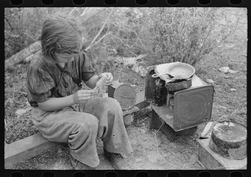 Untitled photo, possibly related to: A child of white migrant in her playhouse. The rusted scales represented a clock to the little girl. Near Harlingen, Texas