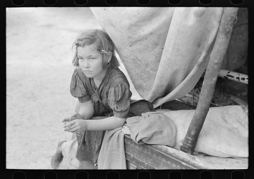 Untitled photo, possibly related to: A child of white migrant in her playhouse. The rusted scales represented a clock to the little girl. Near Harlingen, Texas