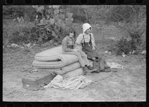 Untitled photo, possibly related to: Children of white migrants from west Texas sitting on mattresses just unloaded from trailer. Harlingen, Texas
