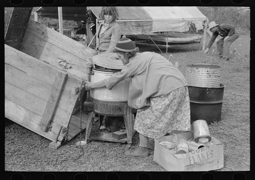 Unloading household goods from trailer in process of setting up camp near Harlingen, Texas
