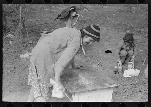 Untitled photo, possibly related to: Wife and daughter of migrant moving furniture into camp near Harlingen, Texas