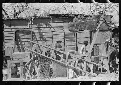 Household equipment in front of home of resident Mexican, San Juan, Texas
