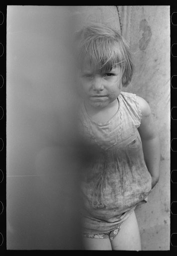 Untitled photo, possibly related to: Child of white migrant worker standing by tent home near Harlingen, Texas