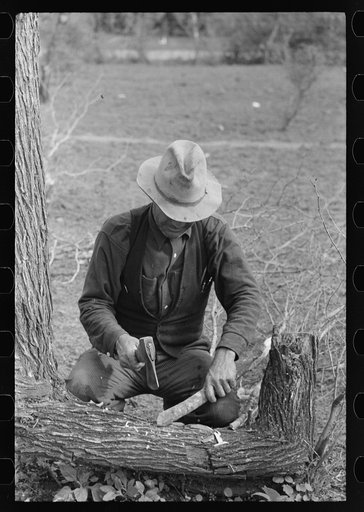 White migrant making stakes for setting up his tent near Harlingen, Texas