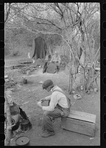 Camp of three white migrant men traveling separately who have set up a camp together near Harlingen, Texas. Two are Texans and one is from Iowa
