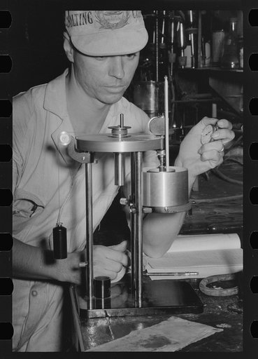 Chemist running test on sweet potato starch, Laurel, Mississippi