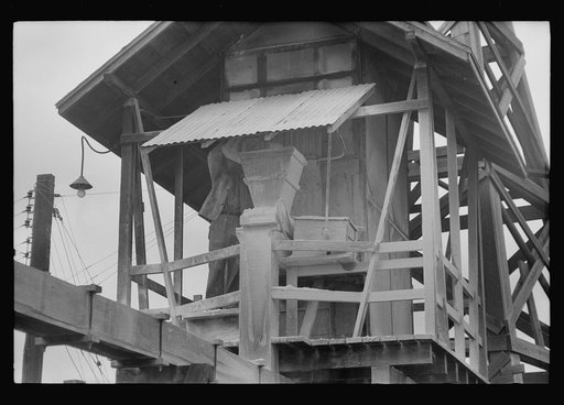 Putting lime into water supply at sweet potato starch plant, Laurel, Mississippi