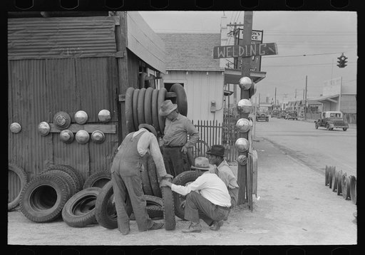 Group of men inspecting secondhand tires for sale, Corpus Christi, Texas