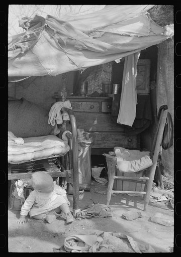 Migrant baby in front of tent, Harlingen, Texas