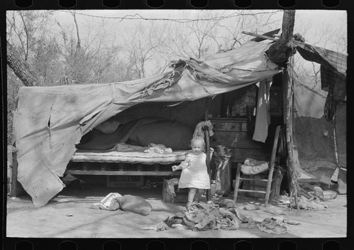 Migrant baby in front of tent, Harlingen, Texas