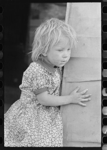 Migrant child standing in doorway of trailer, Edinburg, Texas
