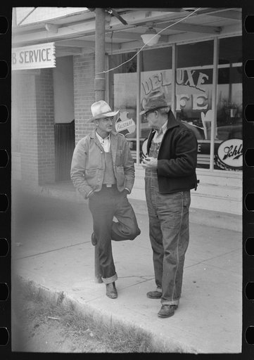 Men talking on sidewalks of Sinton, Texas