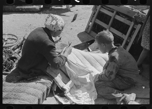 Untitled photo, possibly related to: Wife of migrant auto wrecker sewing seat cushion of wrecked auto, Corpus Christi, Texas