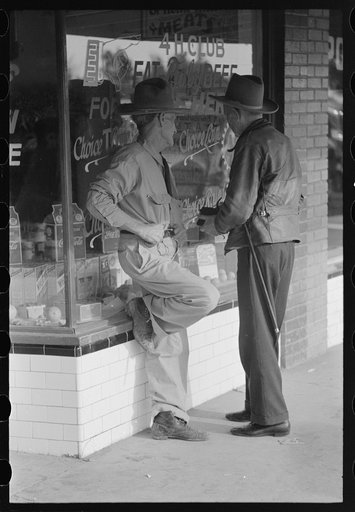 Residents of Crystal City, Texas, talking in front of grocery store