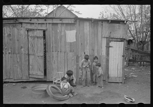 Boys playing in front of backyard house, San Antonio, Texas