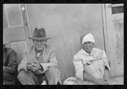 Mexican man and woman waiting for relief commodities, San Antonio, Texas