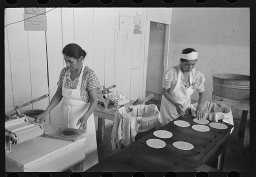 Making tortillas in bake shop, San Antonio, Texas. Tortillas are made of corn flour which is very finely ground and mashed corn. No moisture or baking powder or salt is added