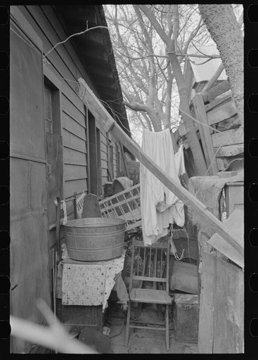 Alleyway leading to corral in Mexican district, San Antonio, Texas. Ten or more houses are built around the corrals which are used as community yards