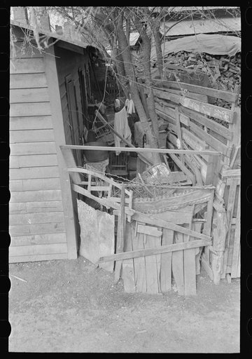 Untitled photo, possibly related to: Alleyway leading to corral in Mexican district, San Antonio, Texas. Ten or more houses are built around the corrals which are used as community yards