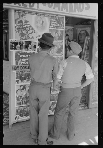Mexican boys looking at movie poster, San Antonio, Texas