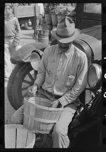 Mexican picking over peas in market in San Antonio, Texas