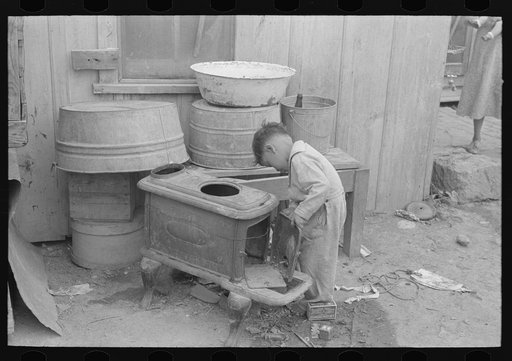 Untitled photo, possibly related to: Overflowing garbage can and other things around back door of Mexican house, San Antonio, Texas. Garbage is collected but once a week in the Mexican district