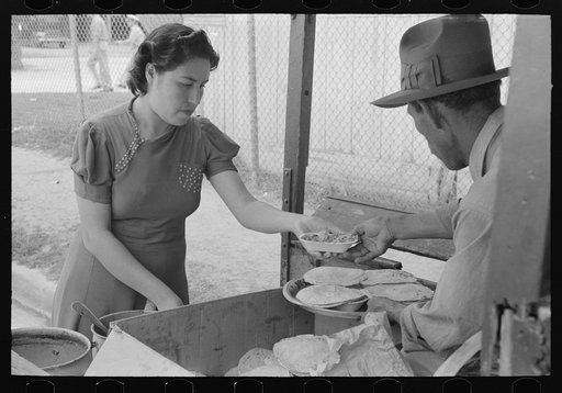 Preparing plates of tortillas and fried beans to sell to pecan shellers, San Antonio, Texas