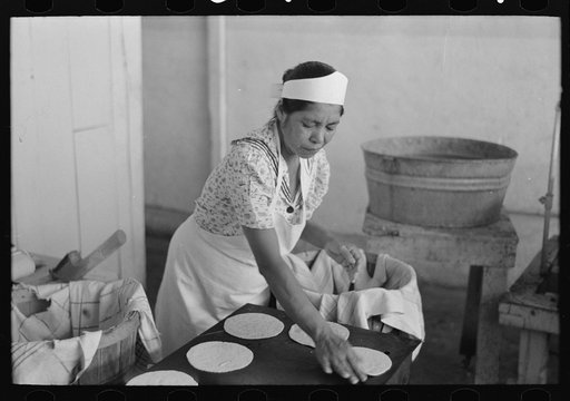 Untitled photo, possibly related to: Counting out tortillas to sell. The price is five cents per dozen. San Antonio, Texas
