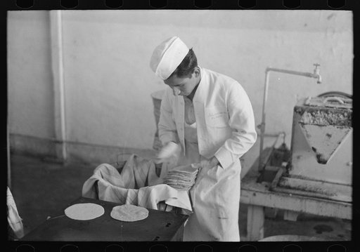 Untitled photo, possibly related to: Counting out tortillas to sell. The price is five cents per dozen. San Antonio, Texas