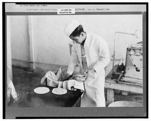 Counting out tortillas to sell. The price is five cents per dozen. San Antonio, Texas