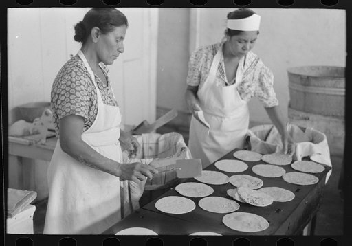 Untitled photo, possibly related to: Counting out tortillas to sell. The price is five cents per dozen. San Antonio, Texas