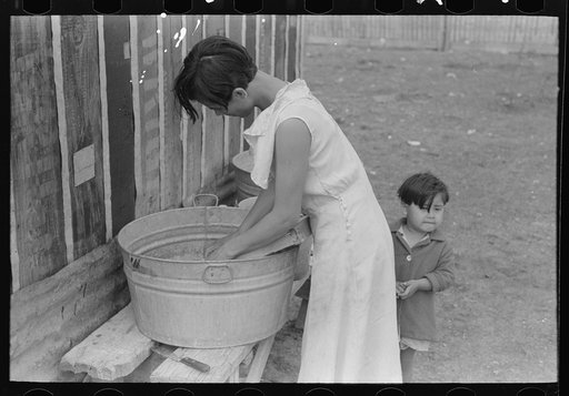 Untitled photo, possibly related to: San Antonio. The Mexican section. Water supply of Mexican family living on the outskirts of town. This water is brought from the city and is delivered by wagon
